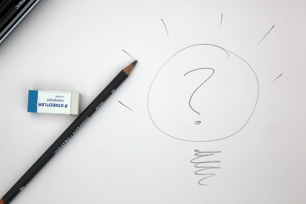 A pencil, paper, and an eraser on compensation consultant’s table.