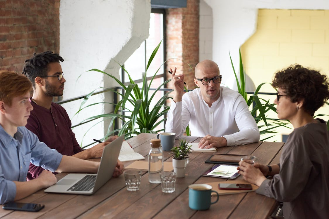 Colleagues of different age groups in a meeting.