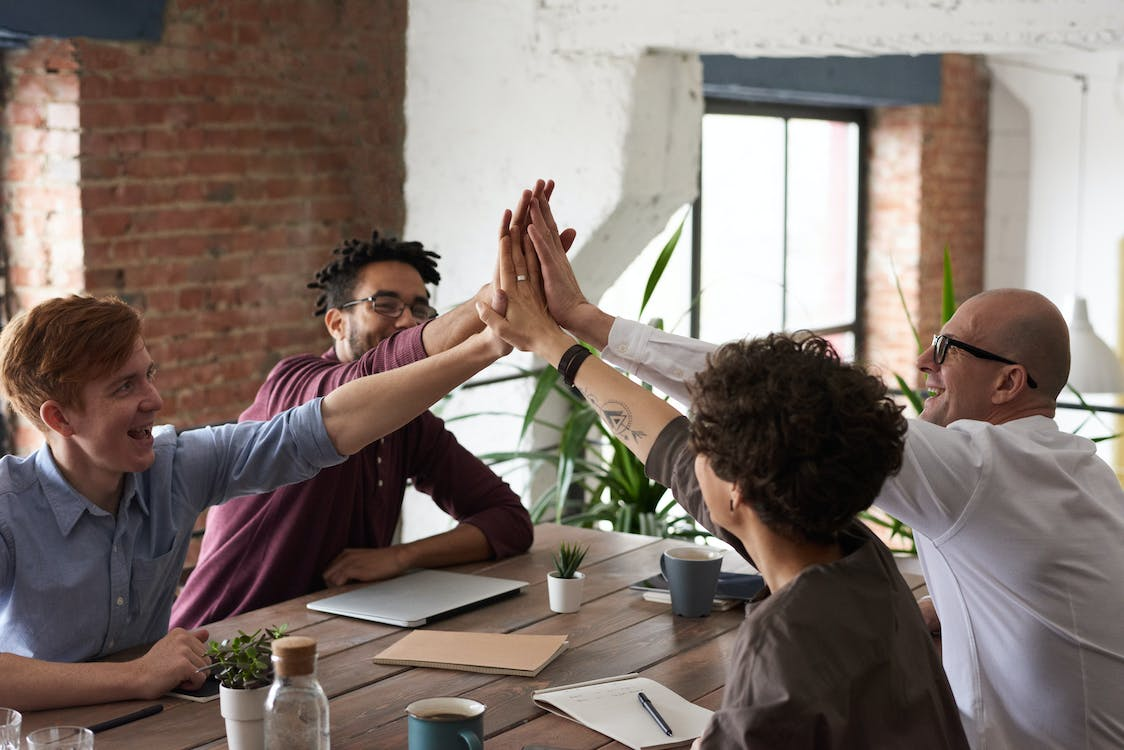 Colleagues high-fiving each other.